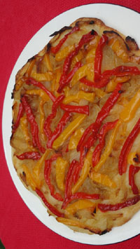 pizza topped with red and yellow peppers